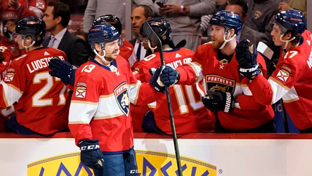 Florida Panthers center Sam Reinhart (13) is congratulated after scoring a goal during the first period of an NHL hockey game against the Tampa Bay Lightning, Sunday, April 24, 2022, in Sunrise, Fla.