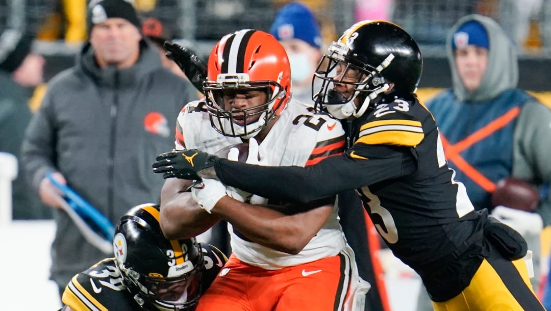 Cleveland Browns running back Nick Chubb (24) is hit by Pittsburgh Steelers cornerback Joe Haden (23) on a long run in the first half of an NFL football game, Monday, Jan. 3, 2022, in Pittsburgh. (AP Photo/Gene J. Puskar)