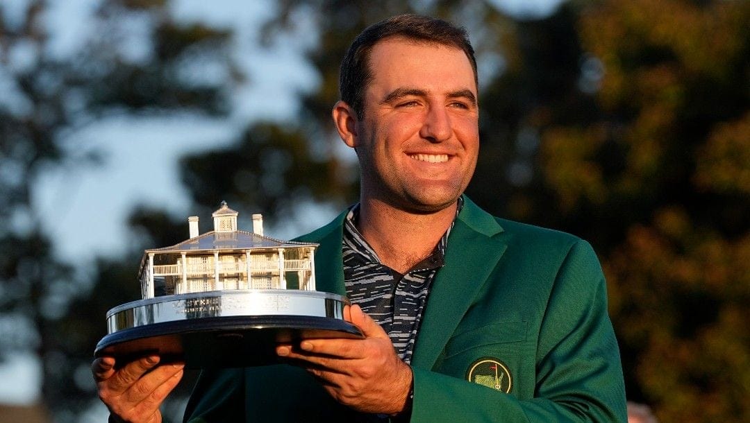 Scottie Scheffler holds the championship trophy after winning the 86th Masters golf tournament on Sunday, April 10, 2022, in Augusta, Ga.