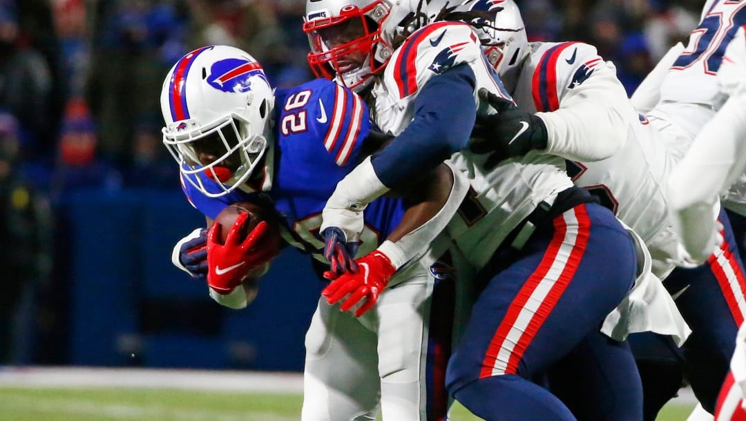 Buffalo Bills running back Devin Singletary (26) is tackled during the first half of an NFL wild-card playoff football game against the New England Patriots in Orchard Park, N.Y., Saturday, Jan. 15, 2022. (AP Photo/ Jeffrey T. Barnes)
