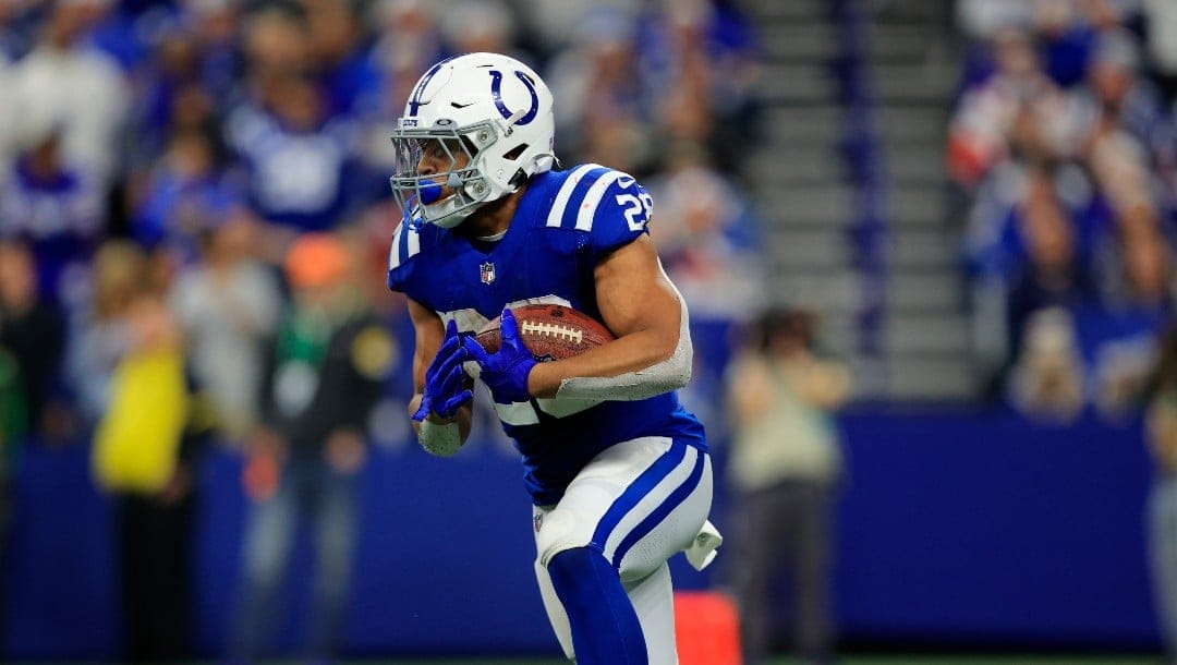 Indianapolis Colts running back Jonathan Taylor (28) runs with the ball during the first half of an NFL football game against the New England Patriots Saturday, Dec. 18, 2021, in Indianapolis. (AP Photo/Aaron Doster)