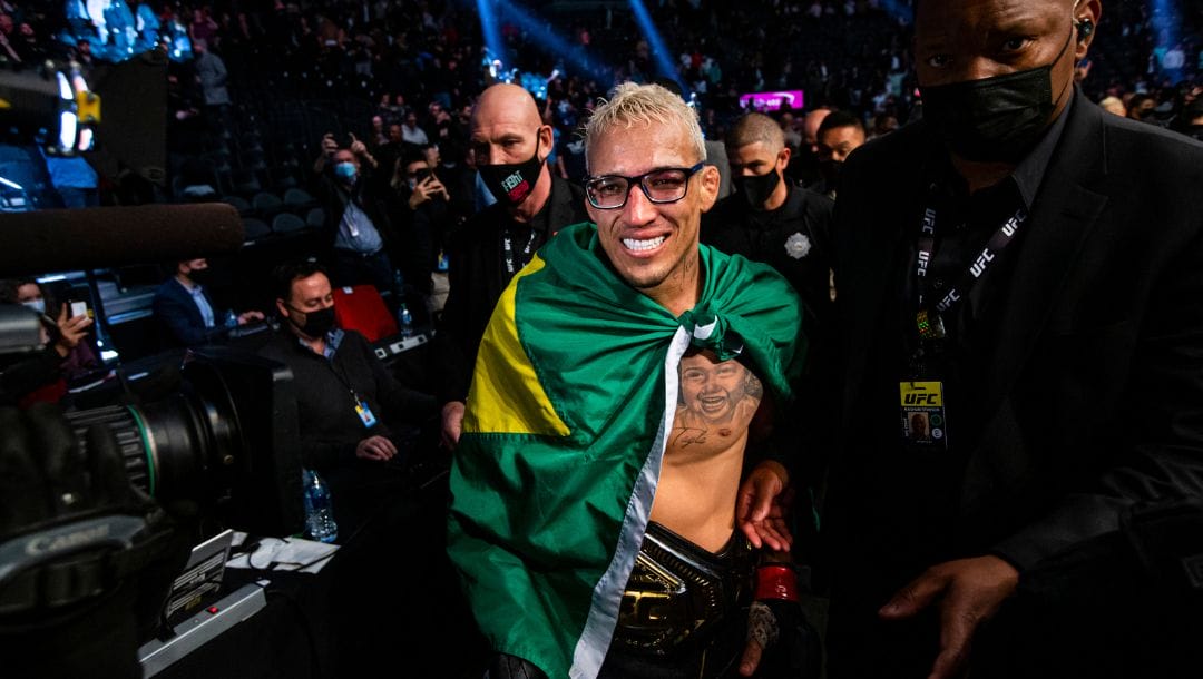 Charles Oliveira leaves the arena after defeating Dustin Poirier, not pictured, by submission.