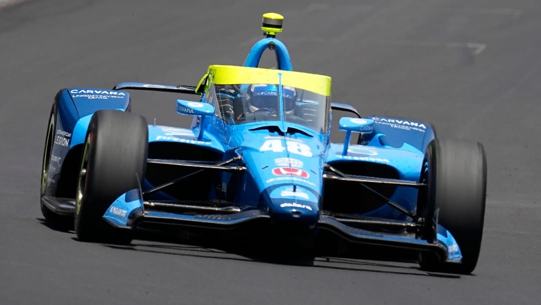 Jimmie Johnson drives into the first turn during the Indianapolis 500 auto race at Indianapolis Motor Speedway, Sunday, May 29, 2022, in Indianapolis. (AP Photo/Darron Cummings)
