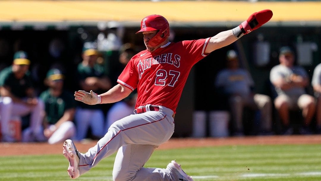 Los Angeles Angels' Mike Trout slides home to score against the Oakland Athletics during the eighth inning of the first baseball game of a doubleheader in Oakland, Calif., Saturday, May 14, 2022.