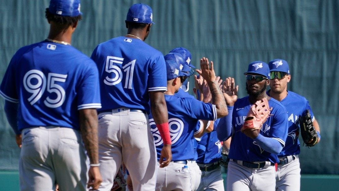 Toronto Blue Jays players celebrate their 9-5 win over the Baltimore Orioles during a spring training baseball game at the Ed Smith Stadium Friday March 18, 2022, in Sarasota, Fla. The Blue Jays won the game 9-5.