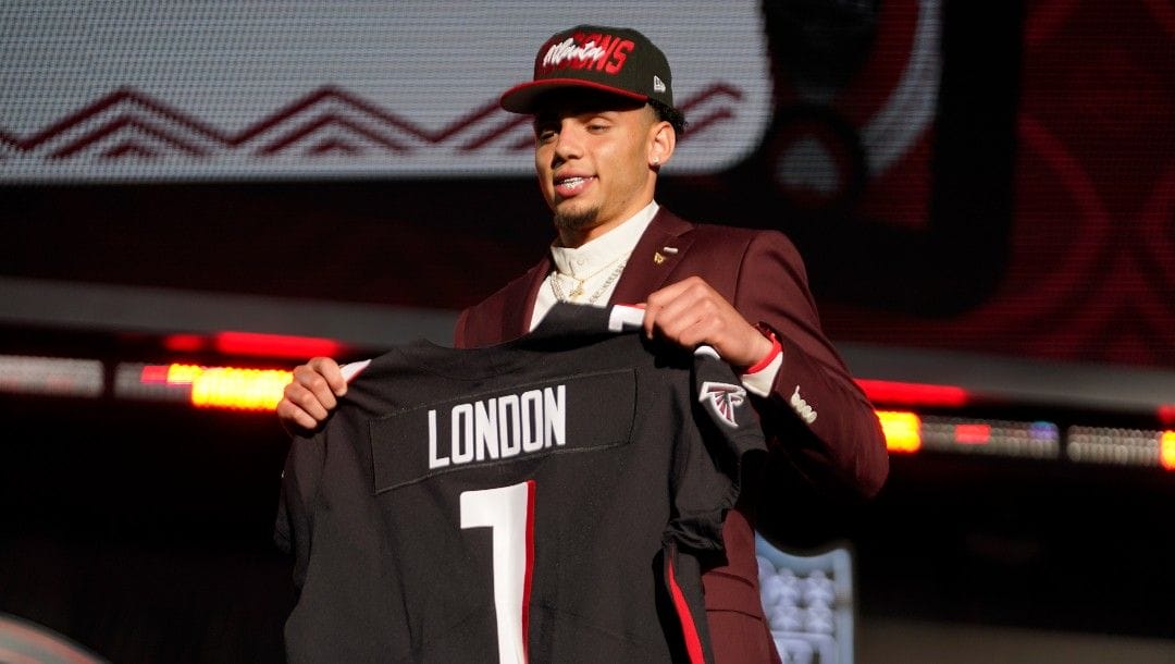 Southern California wide receiver Drake London holds a team jersey after he was chosen by the Atlanta Falcons with the 8th pick at the 2022 NFL Draft, Thursday, April 28, 2022, in Las Vegas.