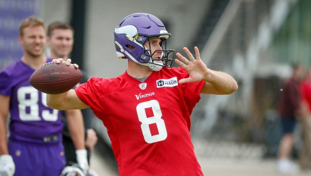 Minnesota Vikings quarterback Kirk Cousins takes part in drills at the NFL football team's practice facility in Eagan, Minn., Tuesday, May 17, 2022.