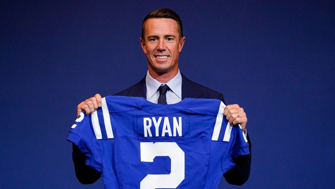 Indianapolis Colts quarterback Matt Ryan holds up his new jersey following a press conference at the NFL team's practice facility in Indianapolis on March 22, 2022.