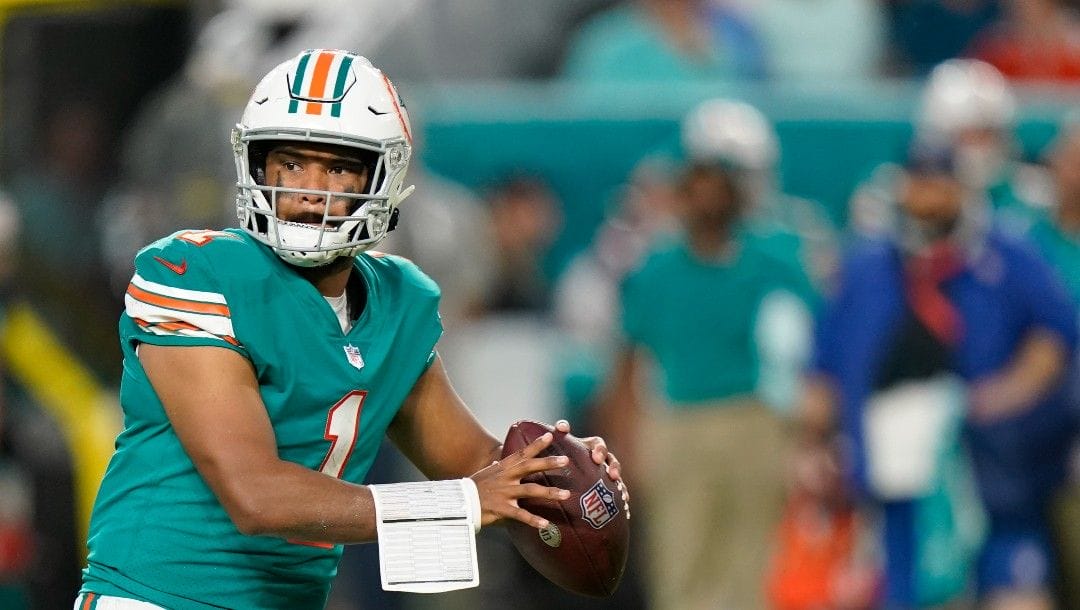 Miami Dolphins quarterback Tua Tagovailoa (1) looks to pass during the first half of an NFL football game against the New England Patriots, Sunday, Jan. 9, 2022, in Miami Gardens, Fla.