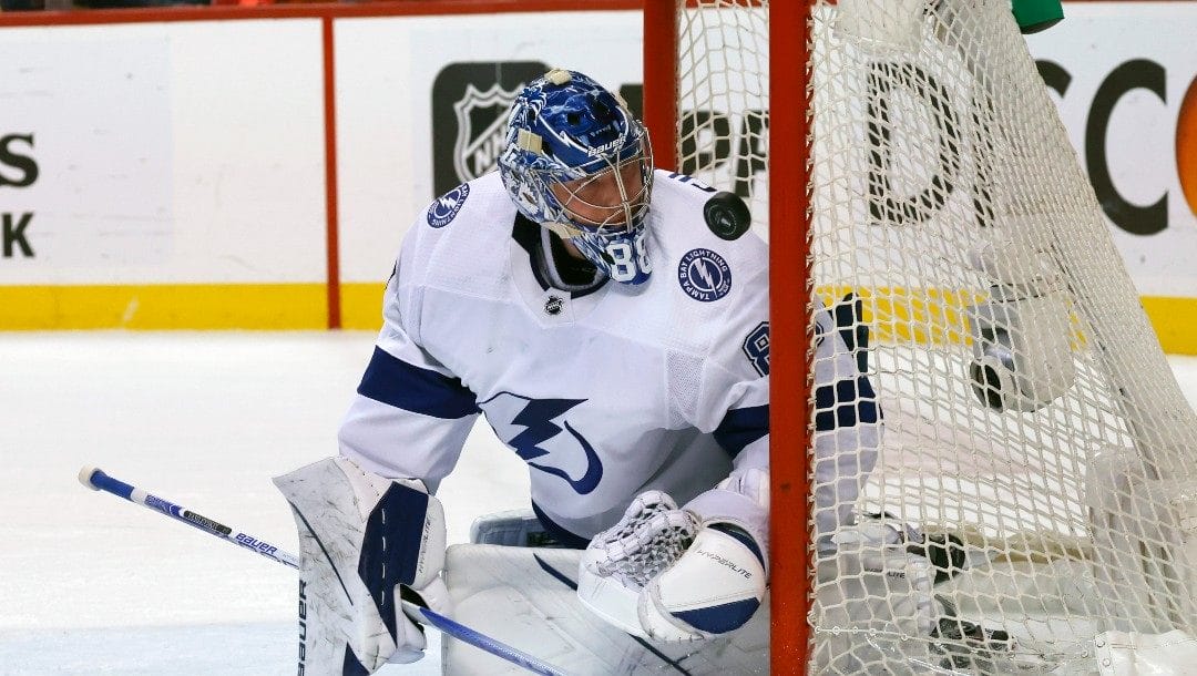 Tampa Bay Lightning goaltender Andrei Vasilevskiy (88) watches as the puck deflects off of the post during the second period of Game 1 of an NHL hockey second-round playoff series against the Florida Panthers Tuesday, May 17, 2022, in Sunrise, Fla.
