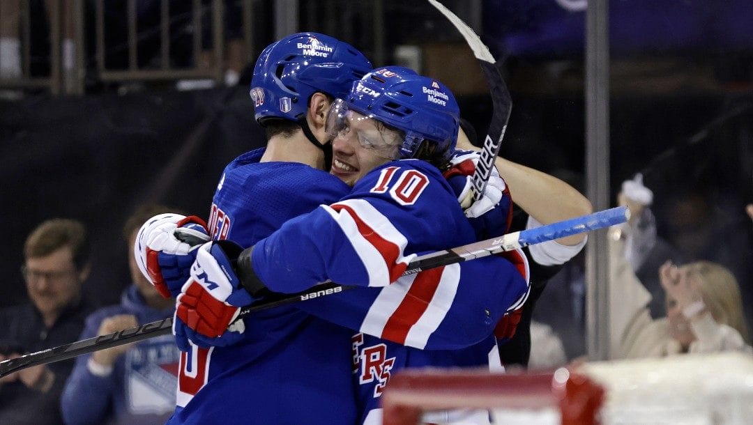 New York Rangers left wing Artemi Panarin (10) hugs Rangers left wing Chris Kreider after scoring the game winning goal against the Pittsburgh Penguins during overtime in Game 7 of an NHL hockey Stanley Cup first-round playoff series Sunday, May 15, 2022, in New York. The Rangers won 4-3 in overtime.