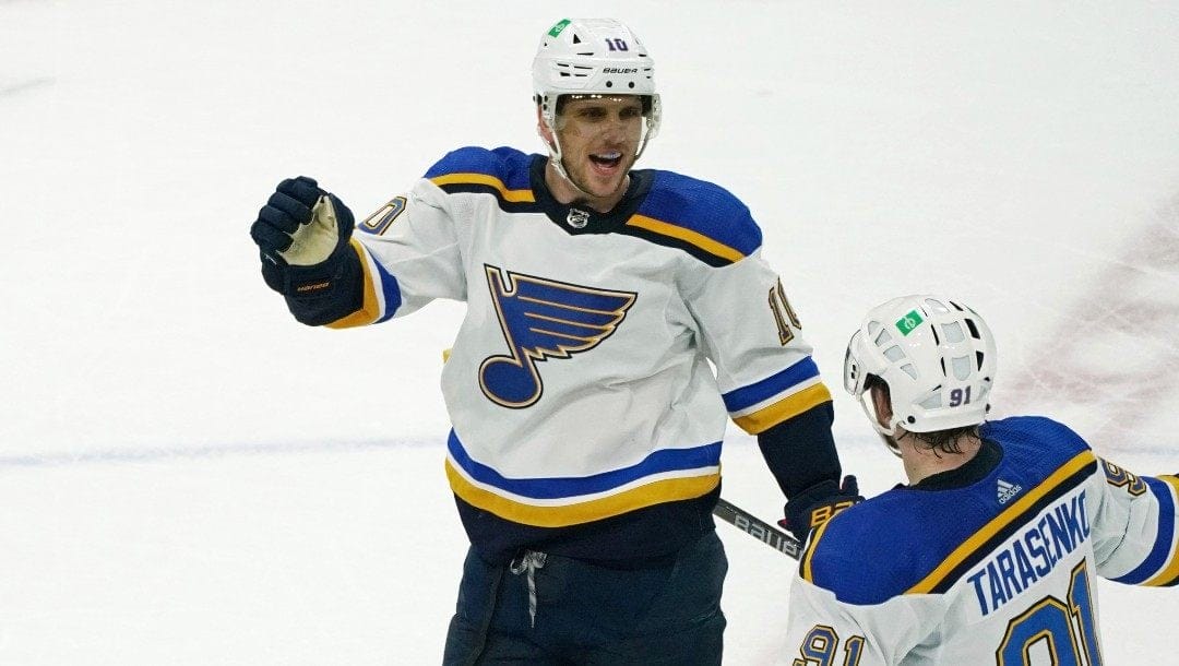 St. Louis Blues' Brayden Schenn (10) skates in to congratulate St. Louis Blues' Vladimir Tarasenko after one of his three goals in the third period of Game 5 of an NHL hockey Stanley Cup first-round playoff series against the Minnesota Wild, Tuesday, May 10, 2022, in St. Paul, Minn. The Blues won 5-2.
