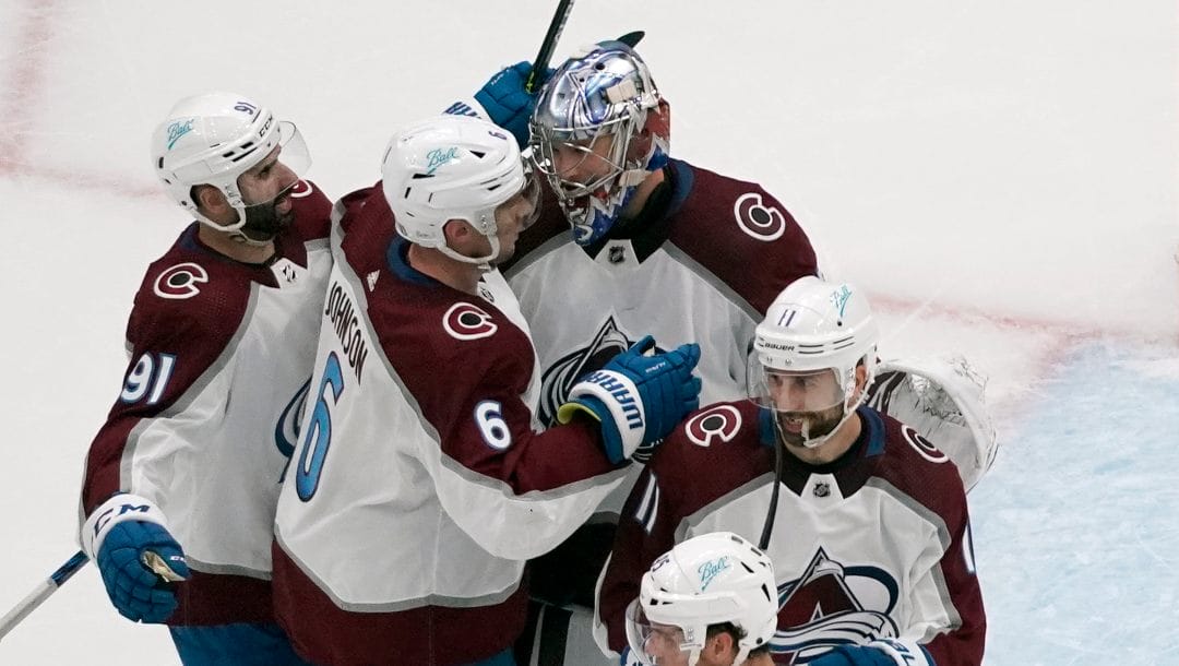 Colorado Avalanche goaltender Darcy Kuemper celebrates with teammates Nazem Kadri (91), Erik Johnson (6) and Andrew Cogliano (11) following a 5-2 victory over the St. Louis B.lues in Game 3