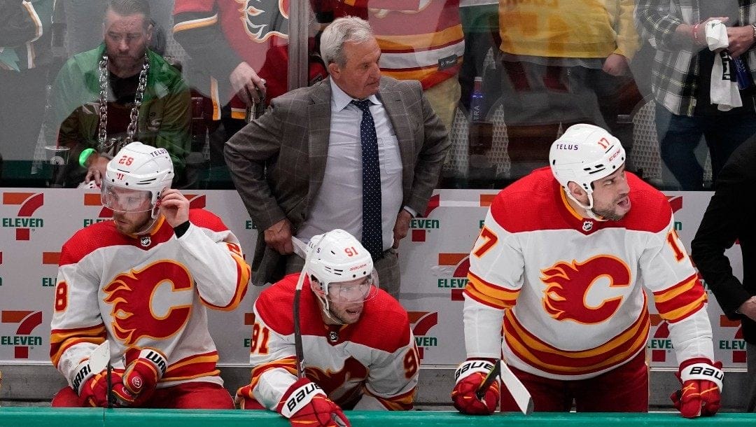 Calgary Flames head coach Darryl Sutter, top center, look son during the third period of Game 6 of an NHL hockey Stanley Cup first-round playoff series against the Dallas Stars, Saturday, May 14, 2022, in Dallas. The Stars won 4-2.