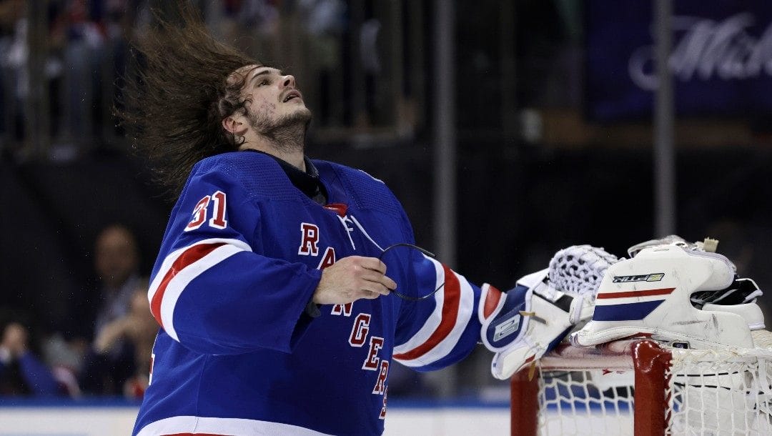 New York Rangers goaltender Igor Shesterkin (31) adjusts his helmet against the Pittsburgh Penguins during the third period in Game 7 of an NHL hockey Stanley Cup first-round playoff series Sunday, May 15, 2022, in New York. The Rangers won 4-3 in overtime.