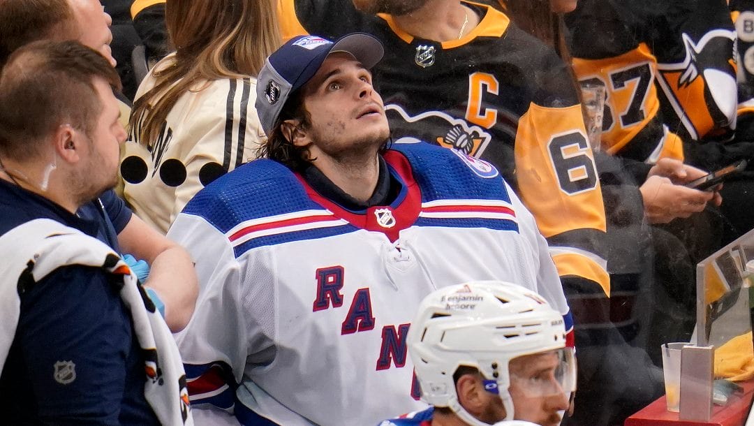 New York Rangers goaltender Igor Shesterkin, center, sits on the bench after being replaced by Alexandar Georgiev during the third period in Game 4 of an NHL hockey Stanley Cup first-round playoff series against the Pittsburgh Penguins in Pittsburgh, Monday, May 9, 2022. The Penguins won 7-2.
