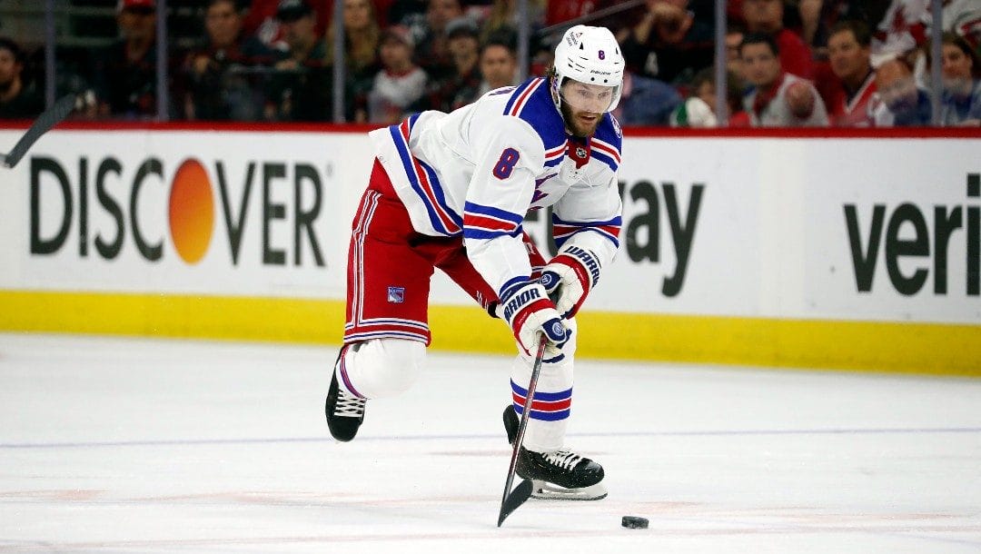 New York Rangers' Jacob Trouba (8) moves the puck against the Carolina Hurricanes during the first period of Game 7 of an NHL hockey Stanley Cup second-round playoff series in Raleigh, N.C., Monday, May 30, 2022.