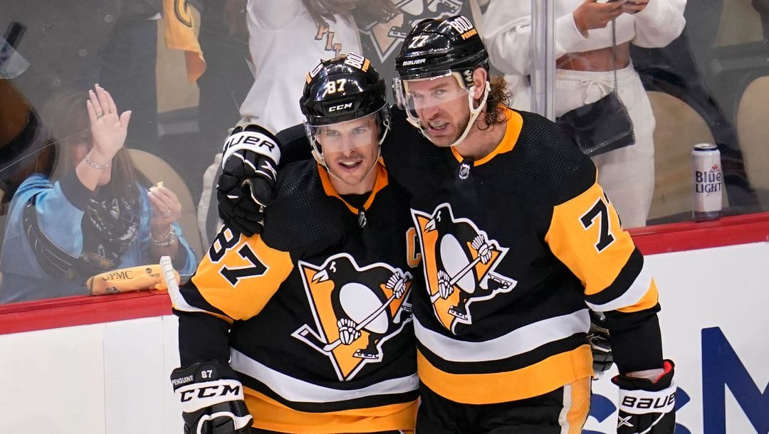 Pittsburgh Penguins' Jeff Carter (77) celebrates his second goal, an empty-net goal during the third period, with Sidney Crosby in Game 3 of an NHL hockey Stanley Cup first-round playoff series against the New York Rangers in Pittsburgh, Saturday, May 7, 2022.
