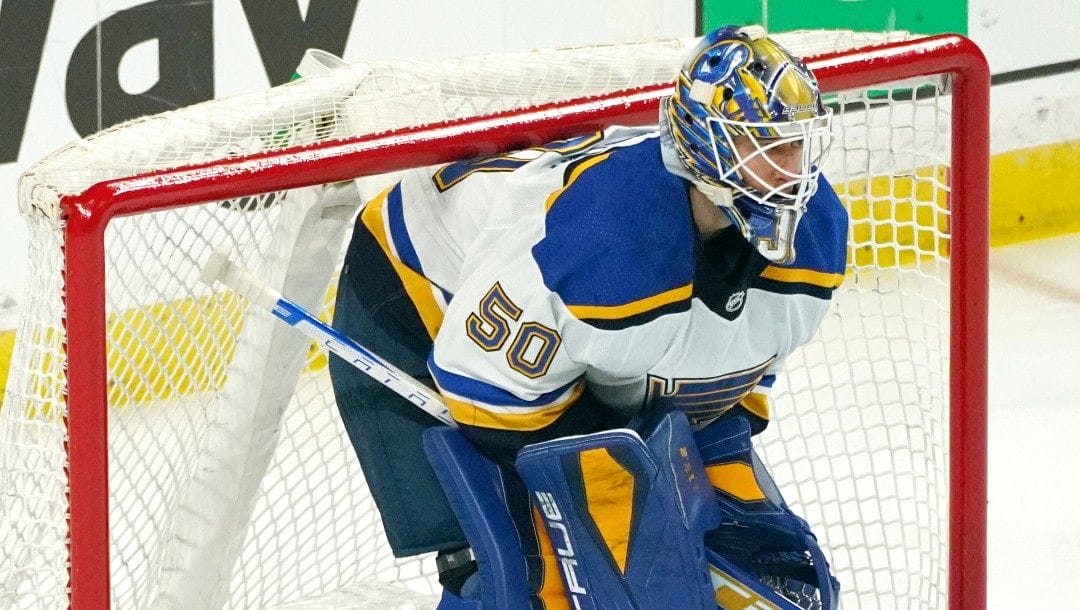 St. Louis Blues goalie Jordan Binnington (50) defends the net against the Minnesota Wild in Game 5 of an NHL hockey Stanley Cup first-round playoff series, Tuesday, May 10, 2022, in St. Paul, Minn.