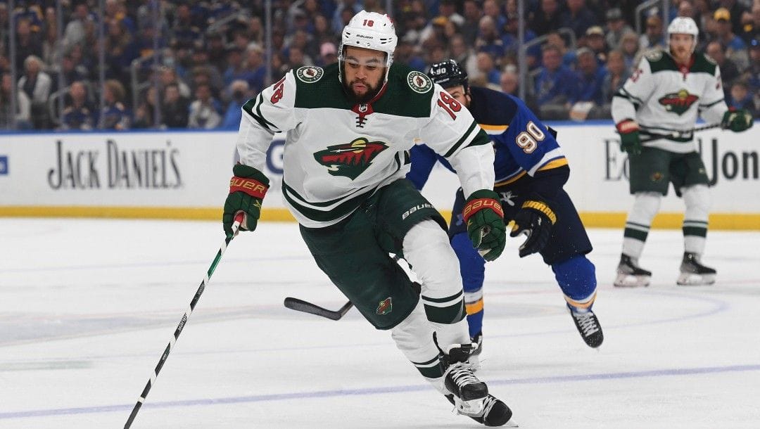 Minnesota Wild's Jordan Greenway (18) advances the puck during the first period in Game 4 of an NHL hockey Stanley Cup first-round playoff series against the St. Louis Blues, Sunday, May 8, 2022, in St. Louis.