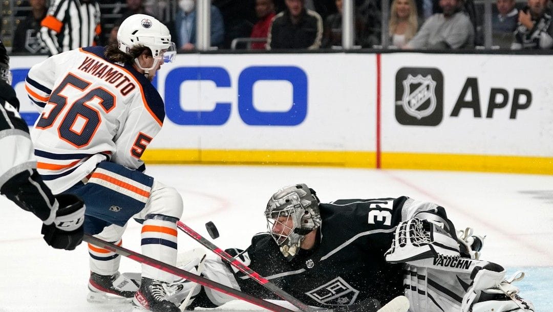 Edmonton Oilers right wing Kailer Yamamoto, left, attempts to score on Los Angeles Kings goaltender Jonathan Quick before colliding with him during the first period in Game 6 of an NHL hockey Stanley Cup first-round playoff series Thursday, May 12, 2022, in Los Angeles.