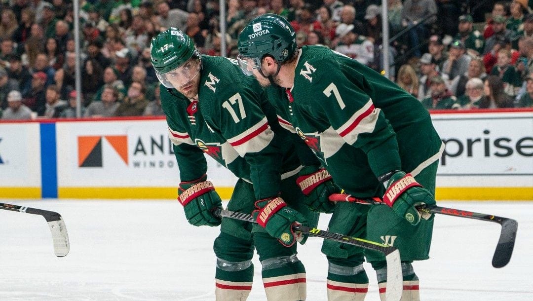 Minnesota Wild left wing Marcus Foligno, left and Minnesota Wild defenseman Dmitry Kulikov during a break in action in the second period of an NHL hockey game Thursday, April 28, 2022, in St. Paul, Minn. The Wild won 3-2 in overtime.