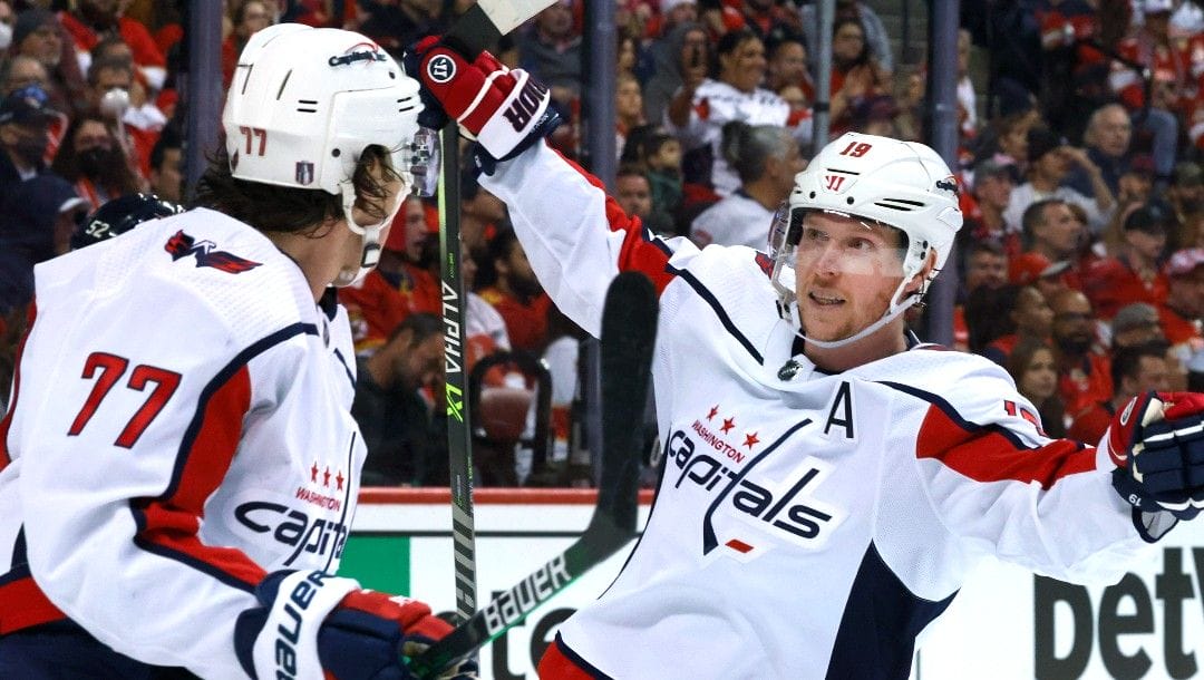 Washington Capitals center Nicklas Backstrom (19) and right wing T.J. Oshie (77) celebrate the go-ahead goal by Oshie during the third period of Game 1 of the team's NHL hockey first-round playoff series against the Florida Panthers on Tuesday, May 3, 2022, in Sunrise, Fla.