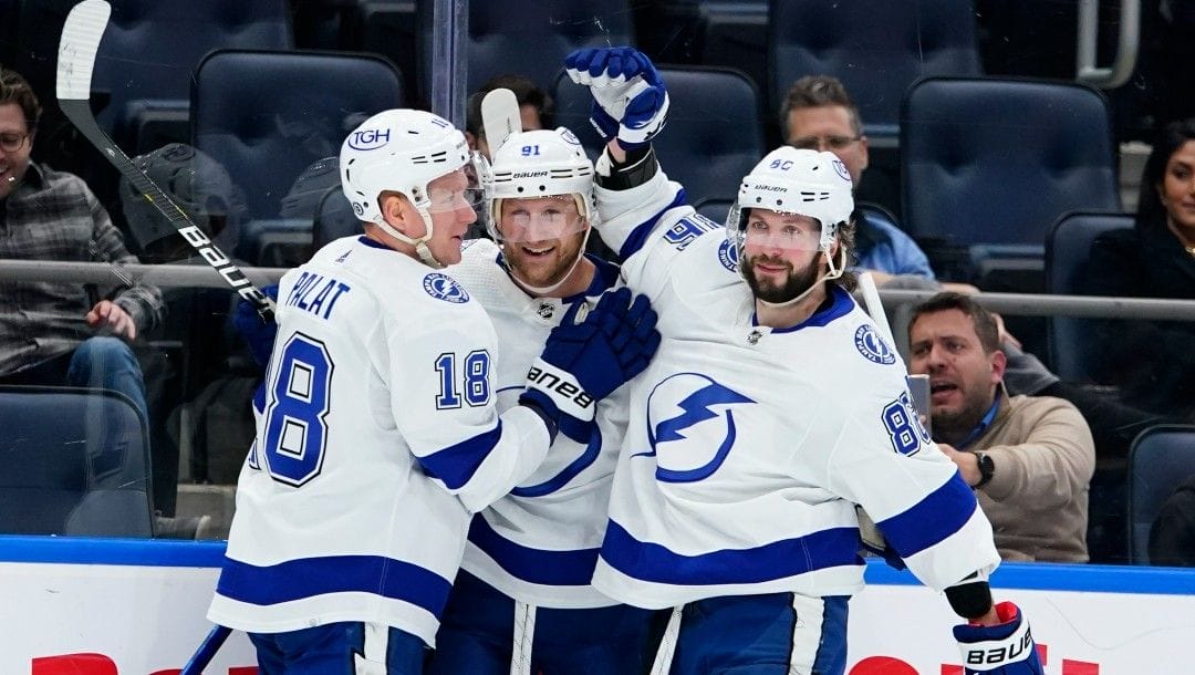 Tampa Bay Lightning's Steven Stamkos (91) celebrates with Ondrej Palat (18) and Nikita Kucherov (86) after scoring a goal during the third period of an NHL hockey game against the New York Islanders Friday, April 29, 2022, in Elmont, N.Y.