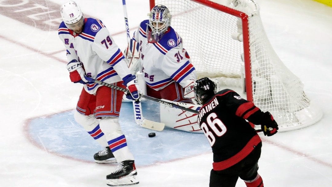 Carolina Hurricanes left wing Teuvo Teravainen (86) shoots against New York Rangers defenseman K'Andre Miller (79) and goaltender Igor Shesterkin (31) during the second period of Game 1 of an NHL hockey Stanley Cup second-round playoff series Wednesday, May 18, 2022 in Raleigh, N.C.