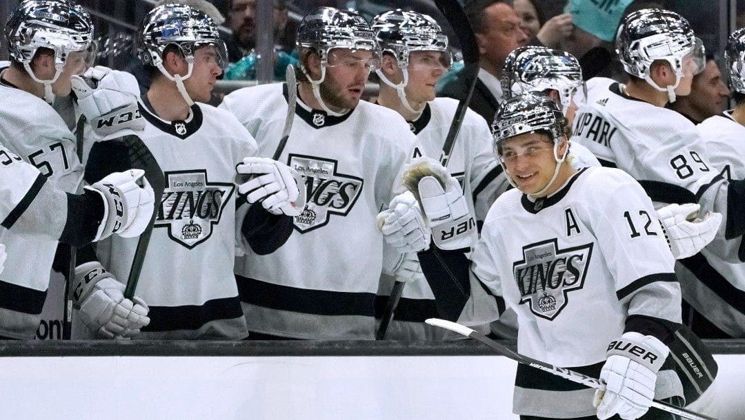 Los Angeles Kings center Trevor Moore (12) is congratulated by teammates after his goal against the Seattle Kraken during the second period of an NHL hockey game, Wednesday, April 27, 2022, in Seattle.
