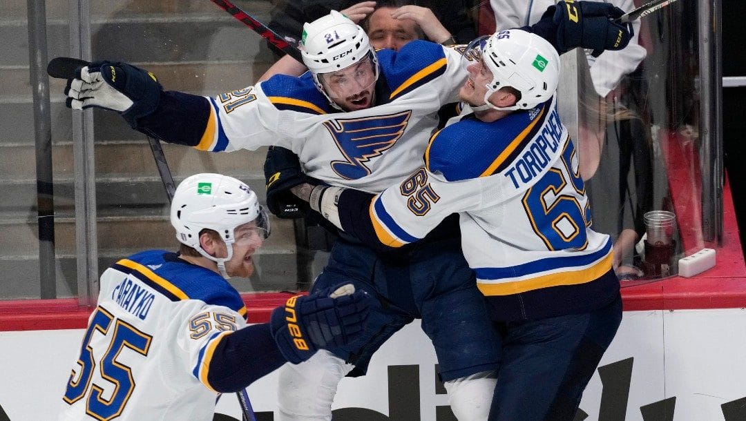 St. Louis Blues center Tyler Bozak, middle, celebrates his overtime goal against the Colorado Avalanche with right wing Alexei Toropchenko in Game 5 of an NHL hockey Stanley Cup second-round playoff series Wednesday, May 25, 2022, in Denver.