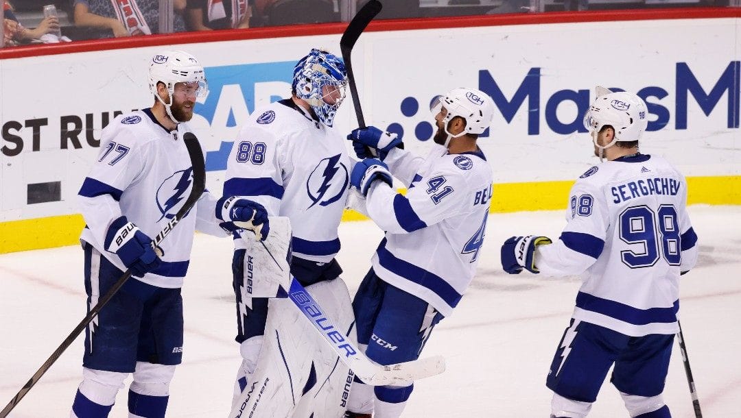 Tampa Bay Lightning goaltender Andrei Vasilevskiy (88) celebrates with defenseman Victor Hedman (77), left wing Pierre-Edouard Bellemare (41) and defenseman Mikhail Sergachev (98) after the team's 2-1 win over the Florida Panthers in Game 2 of an NHL hockey second-round playoff series Thursday, May 19, 2022, in Sunrise, Fla.