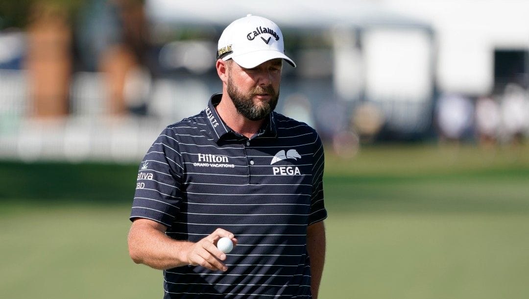 Marc Leishman, of Australia, holds up his ball to the gallery after sinking a putt on the ninth green during the first round of the Arnold Palmer Invitational golf tournament Thursday, March 3, 2022, in Orlando, Fla.