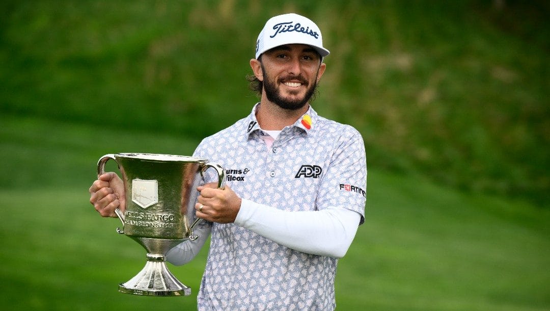 Max Homa holds the trophy after winning the Wells Fargo Championship golf tournament, Sunday, May 8, 2022, at TPC Potomac at Avenel Farm golf club in Potomac, Md.