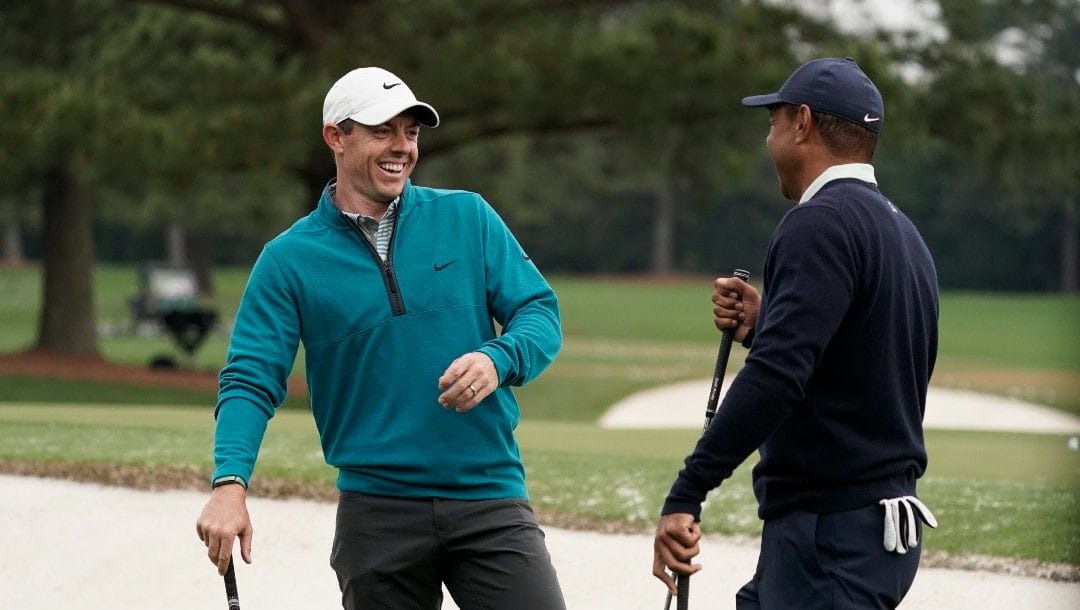 Tiger Woods is greeted by Rory McIlroy, of Northern Ireland during a practice round for the Masters golf tournament on Tuesday, April 5, 2022, in Augusta, Ga.