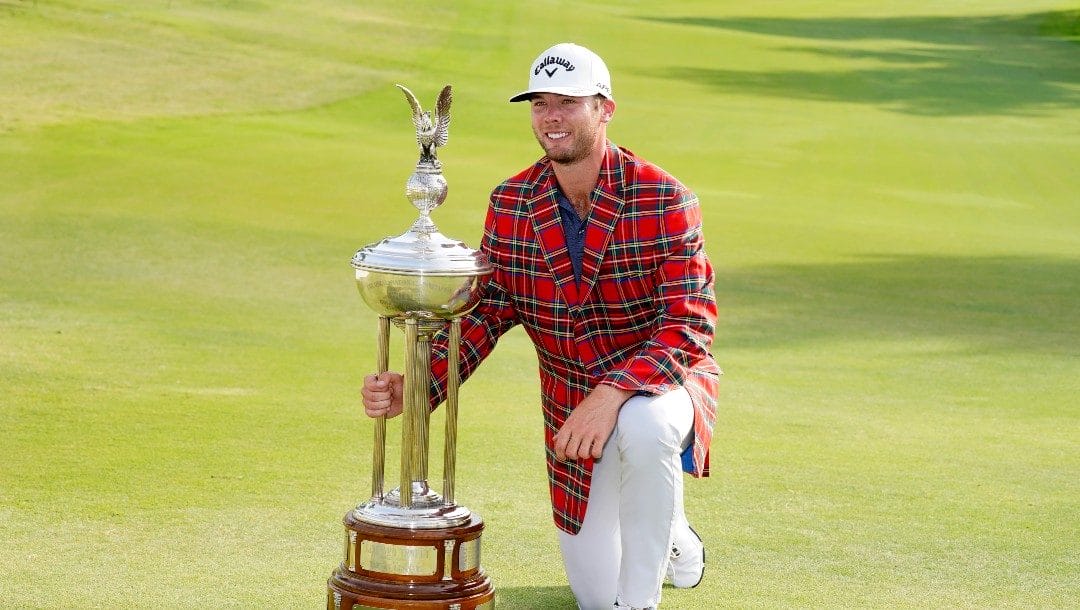 Sam Burns poses with the trophy after winning the Charles Schwab Challenge golf tournament at the Colonial Country Club in Fort Worth, Texas, Sunday, May 29, 2022.