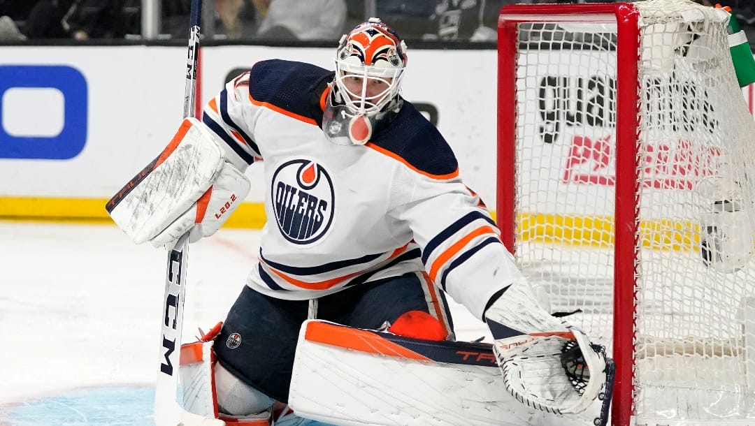 Edmonton Oilers goaltender Mike Smith makes a glove save during the second period in Game 6 of an NHL hockey Stanley Cup first-round playoff series against the Los Angeles Kings Thursday, May 12, 2022, in Los Angeles.