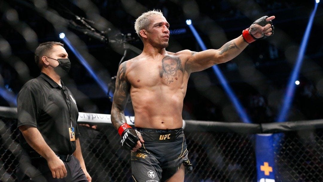 Charles Oliveira reacts after defeating Dustin Poirier, not pictured, by submission in a lightweight mixed martial arts title bout at UFC 269, Saturday, Dec. 11, 2021, in Las Vegas.