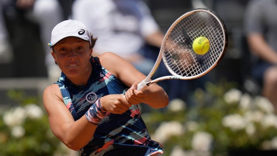 Iga Swiatek of Poland returns the ball to Aryna Sabalenka of Belarus during their semifinal match at the Italian Open tennis tournament, in Rome, Saturday, May 14, 2022.