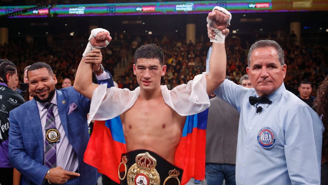Dmitry Bivol, center, celebrates, after defeating Lenin Castillo during a WBA light heavyweight championship boxing bout Saturday, Oct. 12, 2019, in Chicago.