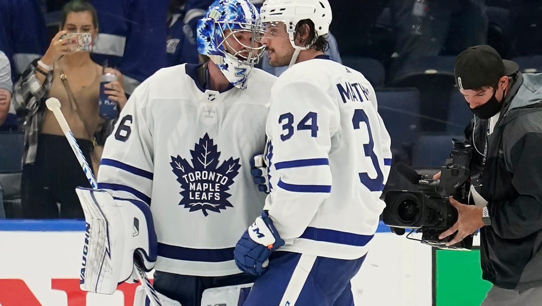 Toronto Maple Leafs goaltender Jack Campbell (36) and center Auston Matthews (34) celebrate after the team defeated the Tampa Bay Lightning during Game 3 of an NHL hockey first-round playoff series Friday, May 6, 2022, in Tampa, Fla.