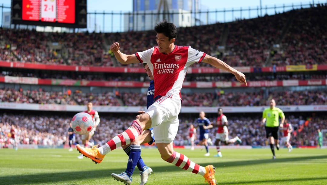 Arsenal's Takehiro Tomiyasu, right, kicks the ball during the English Premier League soccer match between Arsenal and Leeds United at the Emirates Stadium, in London Sunday, May 8, 2022.