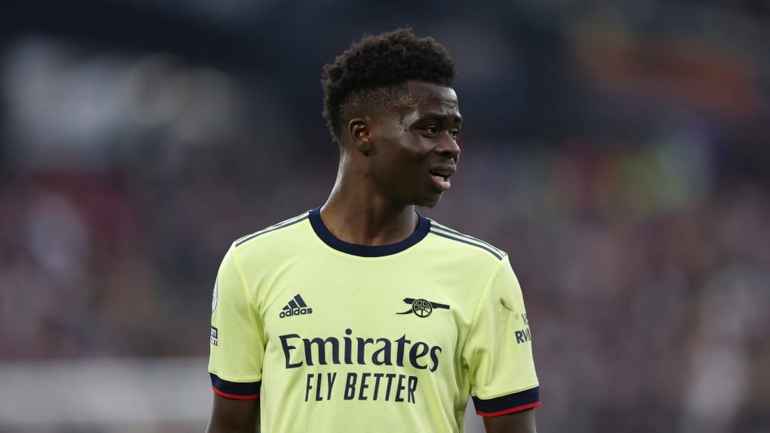 Arsenal's Bukayo Saka waits for a free kick to be taken during the English Premier League soccer match between West Ham United and Arsenal at the London stadium in London, Sunday, May 1, 2022.