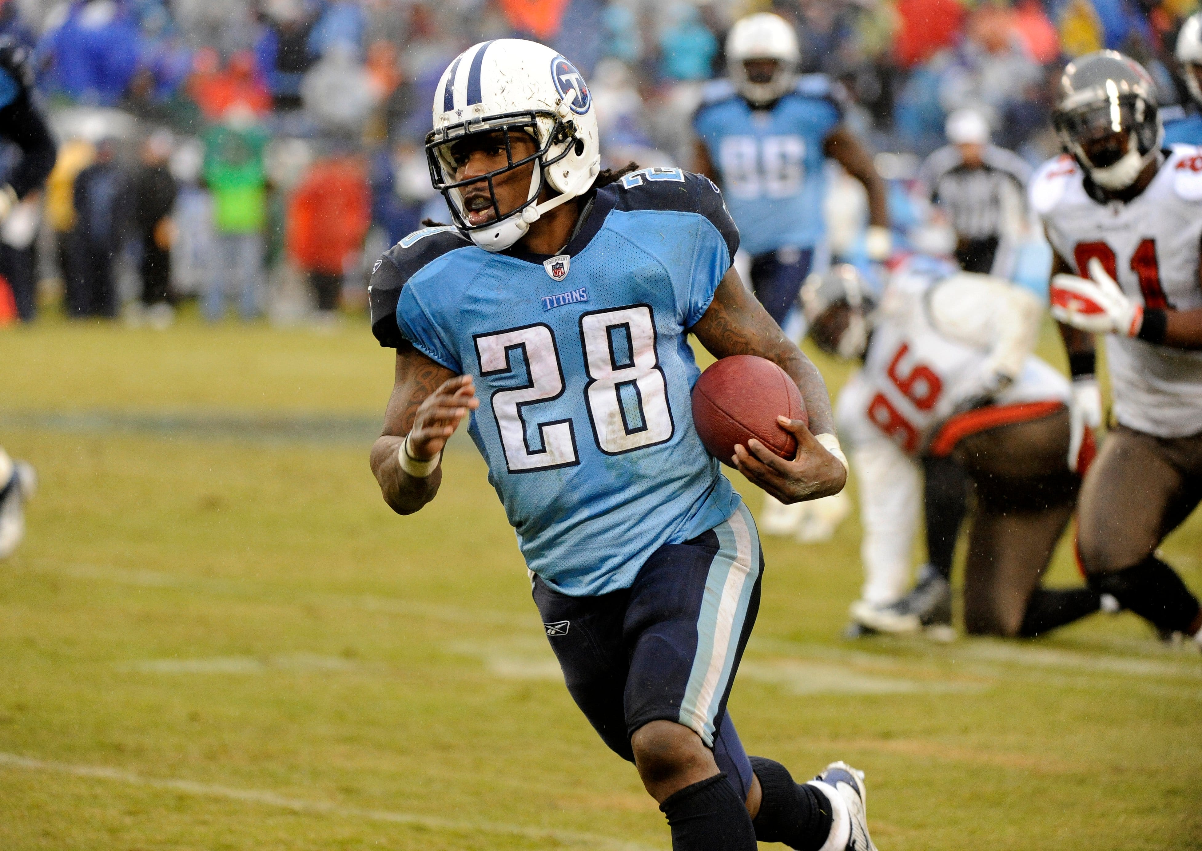 Chris Johnson running with the ball playing for the Tennessee Titans with the number 28
