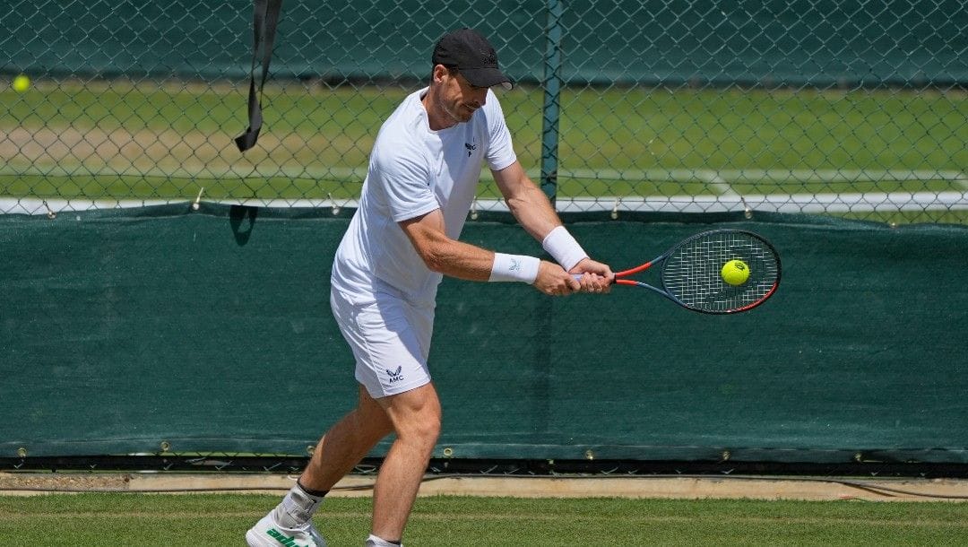 Britain's Andy Murray plays a return as he practices ahead of the Wimbledon tennis championships in London, Sunday, June 26, 2022.