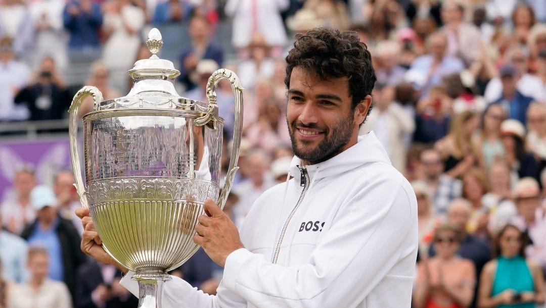 Italy's Matteo Berrettini celebrates with the trophy after beating Serbia's Filip Krajinovic to win the final tennis match at the Queen's Club Championships in London, Sunday, June 19, 2022.