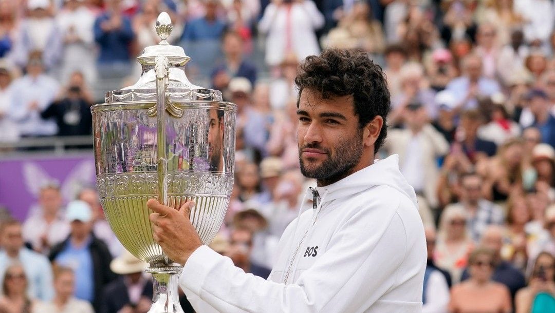 Italy's Matteo Berrettini celebrates with the trophy after beating Serbia's Filip Krajinovic to win the final tennis match at the Queen's Club Championships in London, Sunday, June 19, 2022.