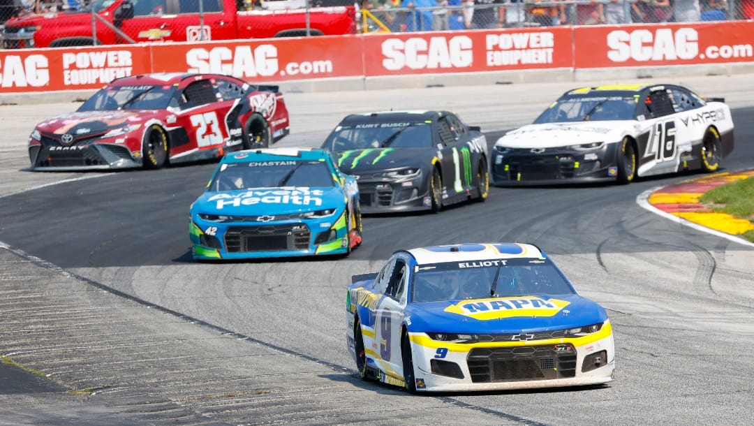 Chase Elliott (9) leads a group through a turn during a NASCAR Cup Series auto race Sunday, July 4, 2021, at Road America in Elkhart Lake, Wis.