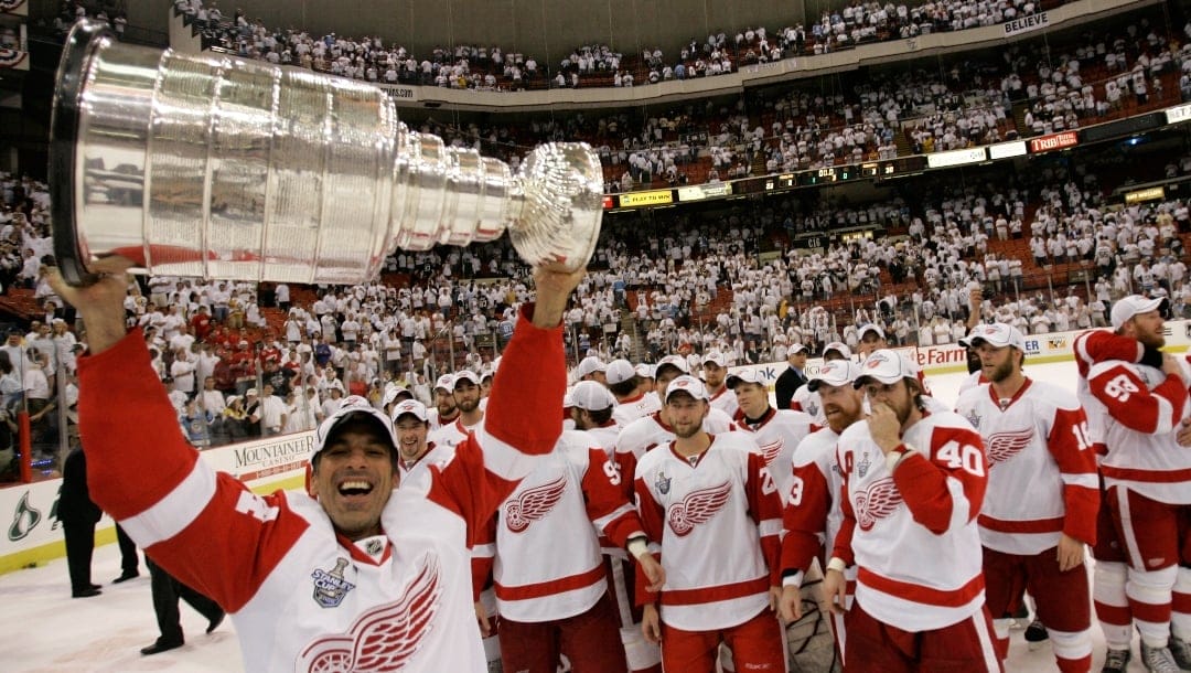 Detroit Red Wings defenseman Chris Chelios (24) holds the Stanley Cup after the Red Wings defeated the Pittsburgh Penguins in Game 6 of the Stanley Cup hockey finals in Pittsburgh, Wednesday, June 4, 2008. (AP Photo/Gene J. Puskar)