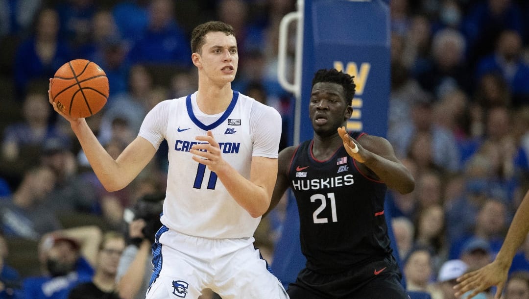 Creighton's Ryan Kalkbrenner (11) plays against Connecticut's Adama Sanogo (21) during the second half of an NCAA college basketball game Wednesday, March 2, 2022, in Omaha, Neb. Creighton defeated Connecticut 64-62. (